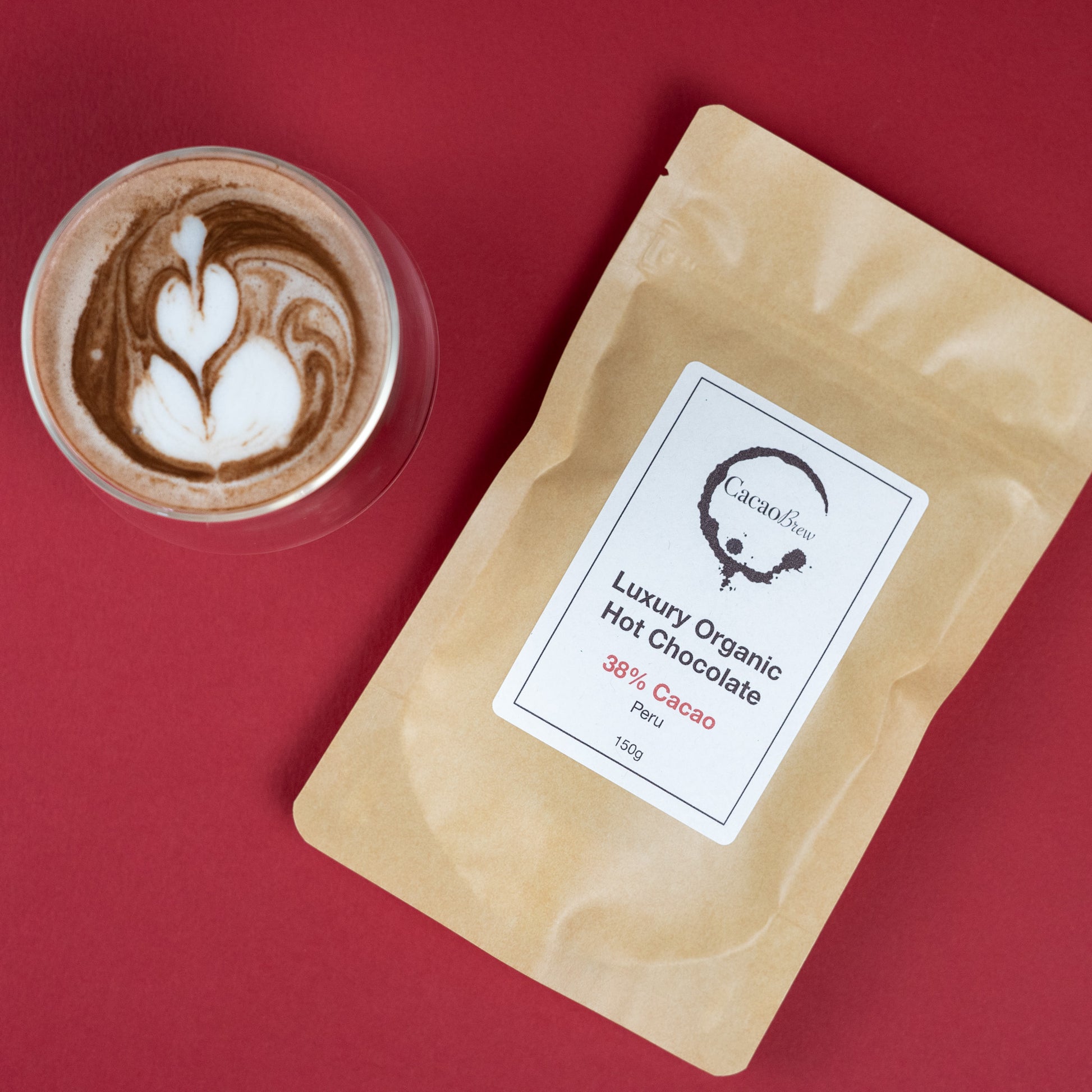 Organic Hot Chocolate 38% Cacao package next to a beautifully crafted hot chocolate beverage.