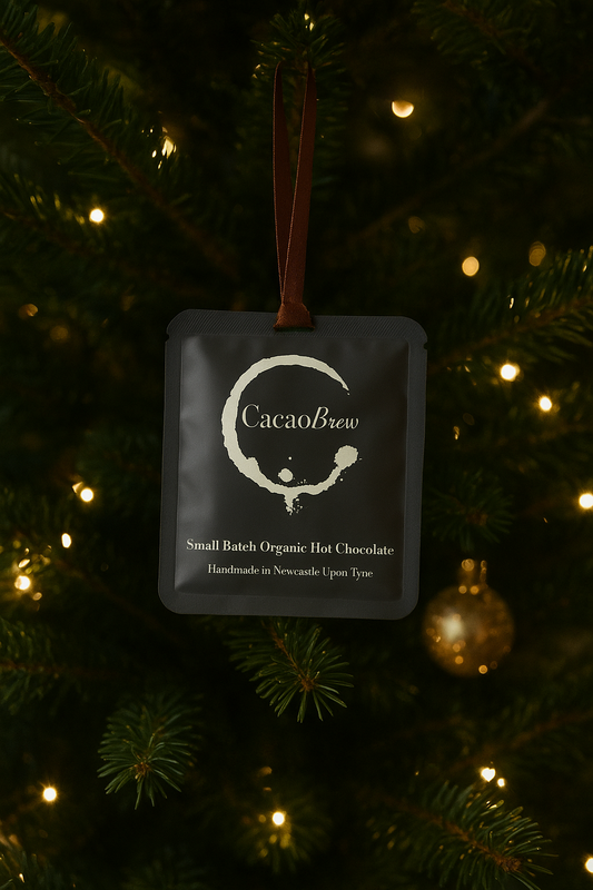 Organic Hot Chocolate sachet hanging from christmas tree with luxurious brown ribbon.